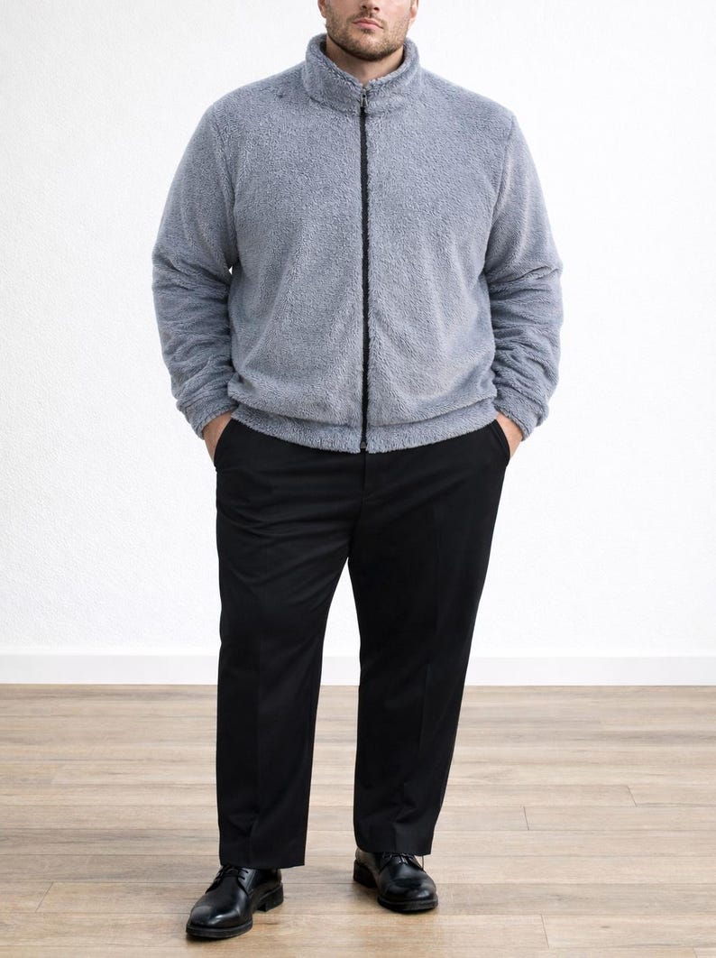 Man wearing a gray zip-up Plus Size Mens Bomber Jacket and black pants on a white background.