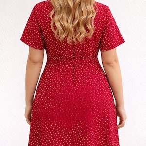 Back view of woman wearing a red floral Ruffle Hem Wrap Mini Dress on a plain background.