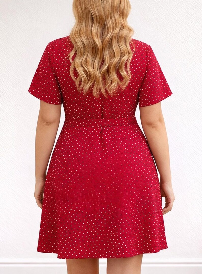 Back view of woman wearing a red floral Ruffle Hem Wrap Mini Dress on a plain background.