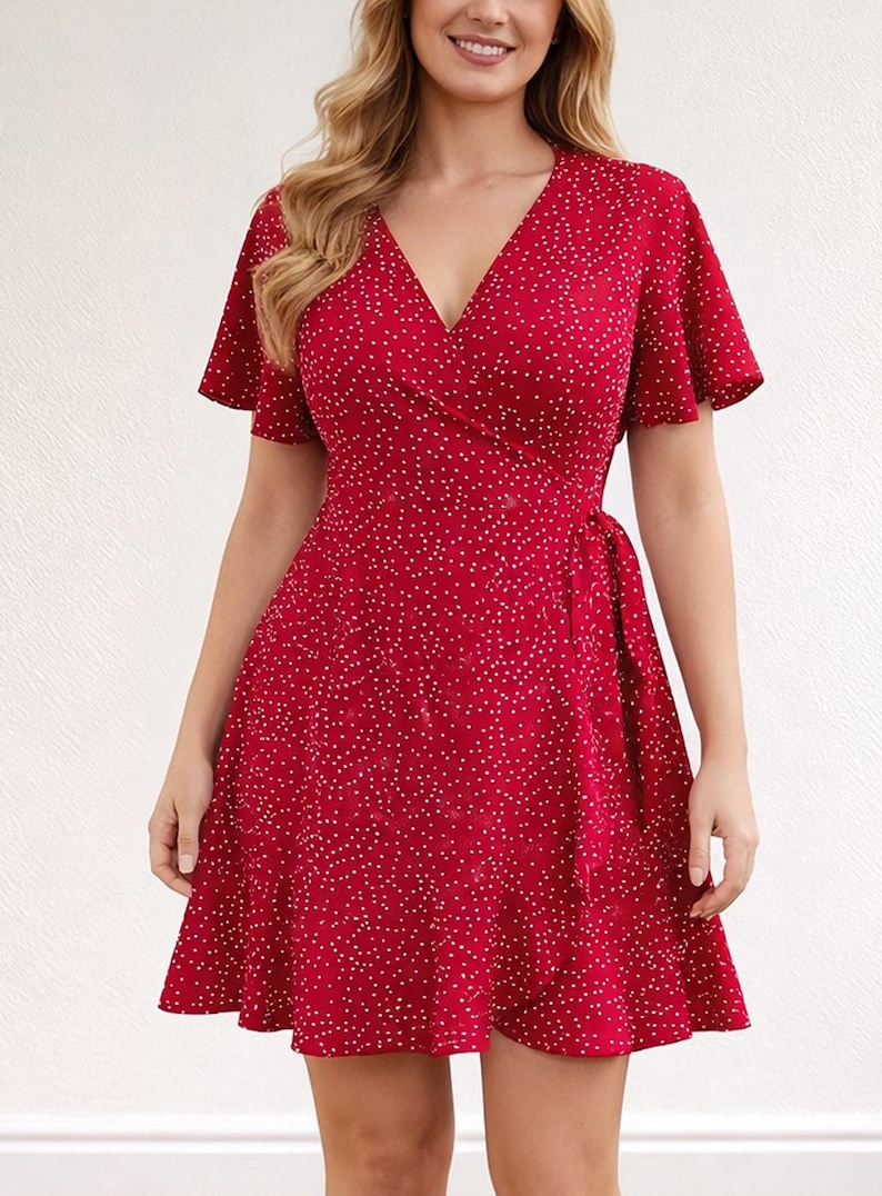 Woman wearing a red floral Ruffle Hem Wrap Mini Dress on a plain background.