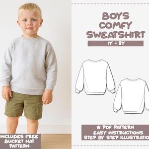May include: A young boy wearing a light gray sweatshirt and olive green shorts. The image includes a pattern for a boys' comfy sweatshirt, sizes 1Y-8Y, with easy instructions and a free bucket hat pattern.