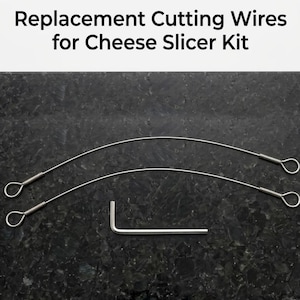 May include: Replacement cutting wires for a cheese slicer kit. The image shows two thin, silver wires with looped ends and a small silver hex key. The text "Replacement Cutting Wires for Cheese Slicer Kit" is at the top.