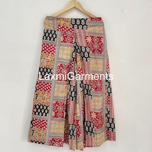 May include: Wide-leg palazzo trousers with a patchwork design. The trousers feature a mix of red, black, and tan squares with floral and geometric patterns. The text "LaxmiGarments" is visible on the image.