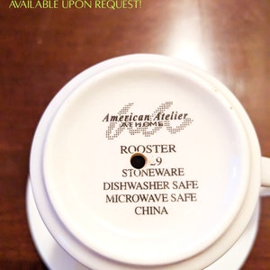 May include: White ceramic planter with a drainage hole, labeled "Rooster" and "American Atelier at Home". The planter is dishwasher and microwave safe and made of stoneware.