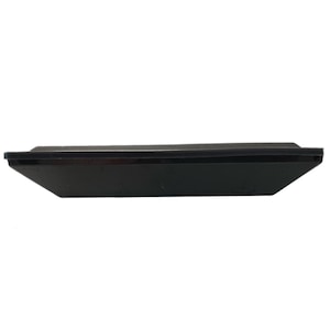 May include: A black rectangular tray with a slightly raised edge. The tray has a matte finish and a simple, minimalist design. The tray is empty and appears to be made of a solid material.