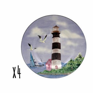 May include: A set of four round ceramic plates featuring a coastal scene with a black and white striped lighthouse, a sailboat on blue water, two flying seagulls, and green foliage. The text X4 is displayed in black to the left of the plates.