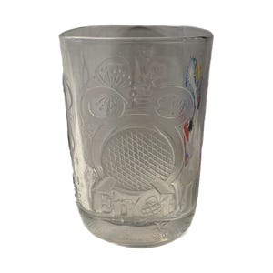 May include: Clear glass tumbler with etched designs. The tumbler features a large Mickey Mouse head, a geometric pattern, and the text "Epcot". Additional etched details include floral and geometric patterns.