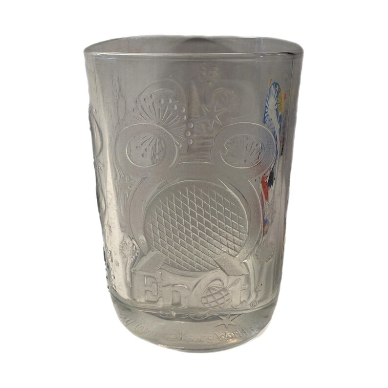 May include: Clear glass tumbler with etched designs. The tumbler features a large Mickey Mouse head, a geometric pattern, and the text "Epcot". Additional etched details include floral and geometric patterns.