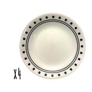 May include: Four white ceramic plates, each with a black border featuring small black squares. The plates are set against a white backdrop. The number "x4" is written in black on the left side.