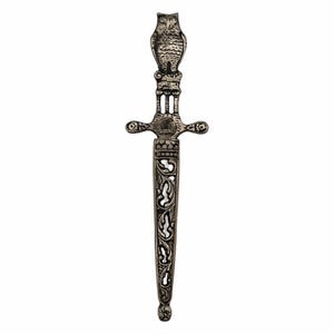 May include: A silver letter opener with an owl-shaped handle. The blade features ornate floral and scrollwork designs. The letter opener is approximately 9 inches long.