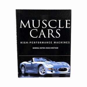 May include: A book titled "Muscle Cars" with the subtitle "High-Performance Machines" and the general editor Craig Cheetham. The cover shows a silver convertible sports car on a black background.