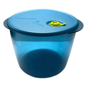 May include: A blue Tupperware container with a matching lid. The lid has a yellow tab and the word "Tupperware" printed on it. The container is made of a translucent plastic material.