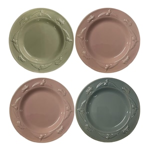 May include: Set of four ceramic plates with a raised bunny design around the rim. The plates are in shades of green, pink, and blue.