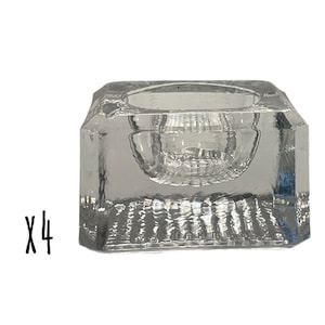 Può includere: Set di quattro portacandele quadrati in vetro trasparente con un piccolo centro rotondo incassato. I portacandele sono testurizzati e hanno un aspetto smerigliato.  X4