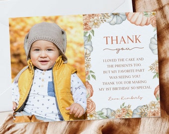 May include: A thank you card featuring a photo of a baby boy wearing a yellow vest and a brown hat. The card has a watercolour design with pumpkins, flowers, and the text "THANK you I LOVED THE CAKE AND THE PRESENTS TOO. BUT MY FAVORITE PART WAS SEEING YOU! THANK YOU FOR MAKING MY 1ST BIRTHDAY SO SPECIAL Love Kimberly".