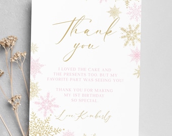 May include: A white thank you card with gold and pink snowflakes. The card says "Thank you" in gold script and includes the text "I loved the cake and the presents too, but my favorite part was seeing you! Thank you for making my 1st birthday so special. Love Kimberly."