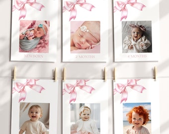 May include: Six photo cards with pink bows and white backgrounds. Each card features a baby at different ages, with the age labeled below the photo. The ages are: Newborn, 2 months, 4 months, 6 months, 9 months, and 12 months.