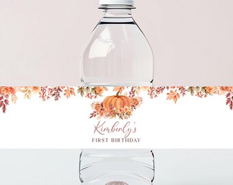 May include: Water bottle label with a fall theme. The label features a pumpkin, leaves, and the text "Kimberly's First Birthday".