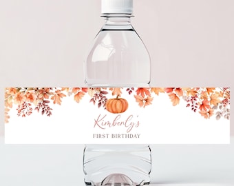 May include: Water bottle label with a fall theme. The label features a pumpkin, leaves, and the text "Kimberly's First Birthday".