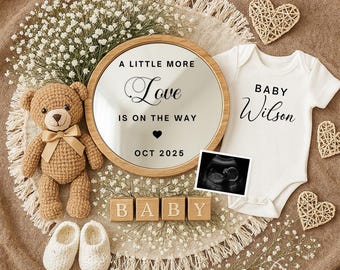 May include: A pregnancy announcement with a mirror inscribed "A Little More Love Is On The Way" and "Oct 2025". Includes a baby onesie, ultrasound image, teddy bear, baby shoes, and wooden blocks spelling "BABY".