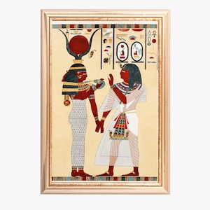 May include: A framed print depicting an ancient Egyptian scene. Two figures, one with a red headdress and the other in white robes, are engaged in a ritual. The artwork features vibrant colors and intricate details, set against a beige background with hieroglyphs.