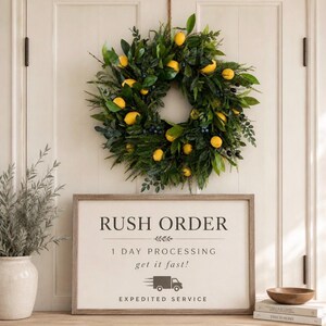 May include: A circular wreath featuring green leaves and yellow lemons hanging above a rectangular sign with the text RUSH ORDER, 1 DAY PROCESSING, get it fast!, and EXPEDITED SERVICE, accompanied by a truck icon and a small wooden bowl.