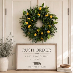 May include: A circular wreath featuring green leaves and yellow lemon accents hangs above a rectangular sign with the text RUSH ORDER, 1 DAY PROCESSING, get it fast!, and EXPEDITED SERVICE, accompanied by a small truck icon and stacked books.