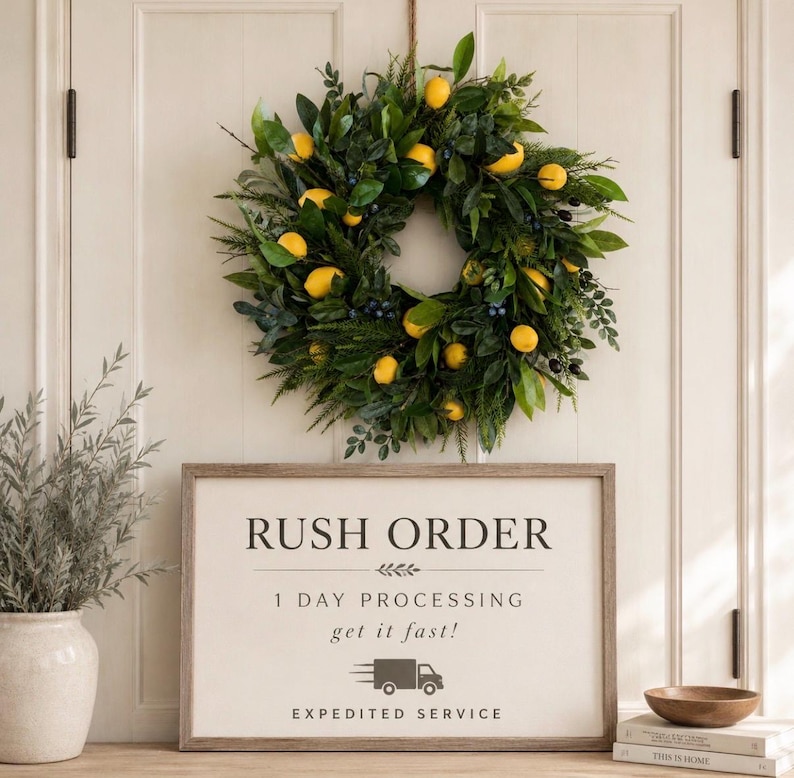May include: A circular wreath featuring green leaves and yellow lemon accents hangs above a rectangular sign with the text RUSH ORDER, 1 DAY PROCESSING, get it fast!, and EXPEDITED SERVICE, accompanied by a small truck icon and stacked books.
