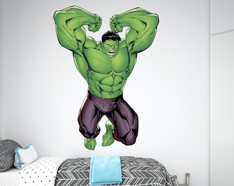 May include: A green Hulk character wall decal with a purple and black costume, with the character's arms raised in a powerful pose. The decal is shown on a white wall in a bedroom setting.