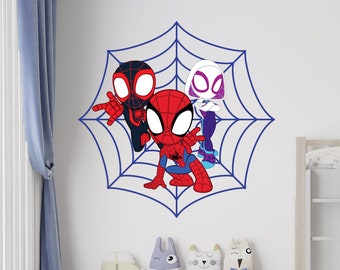 May include: A wall sticker depicting three cartoon Spider-Man characters within a blue spiderweb design. The characters are in red, black, white, and blue. Suitable for a child's bedroom or play area.