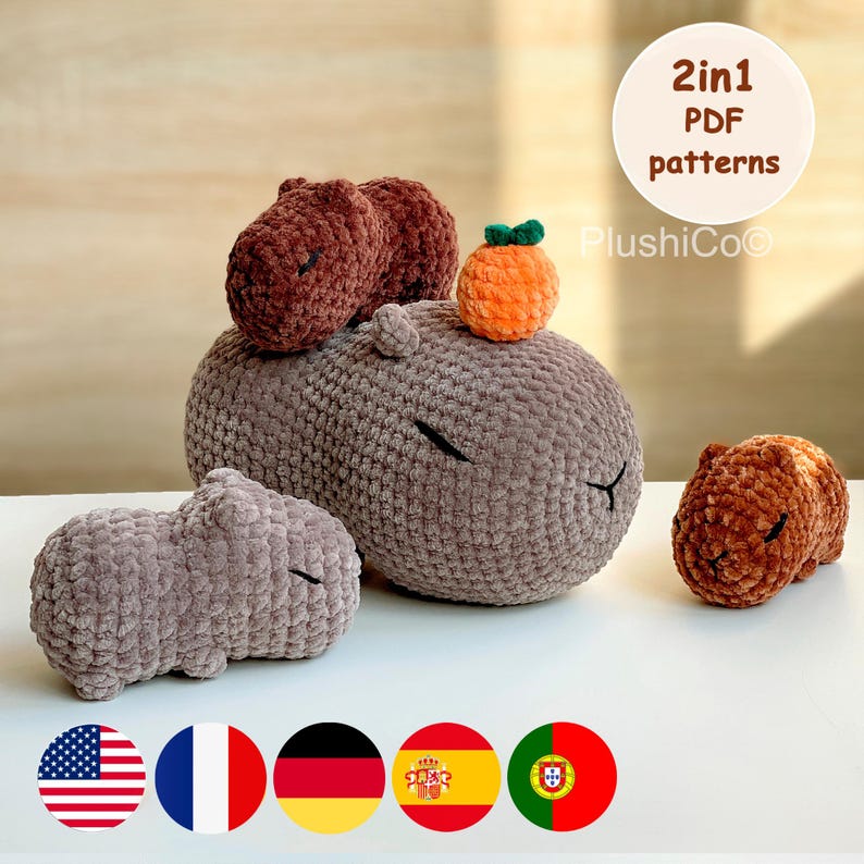 May include: A set of four crocheted amigurumi capybara plushies. The plushies are brown and gray and are arranged in a pyramid shape. The largest plushie is sitting on a table with a small orange crocheted plushie on top of its head. The text "2in1 PDF patterns" and "PlushiCo&copy;" is visible in the image.