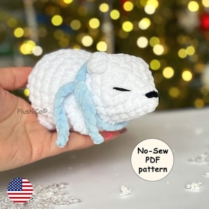 May include: White crocheted polar bear with a blue scarf. No-Sew PDF pattern.