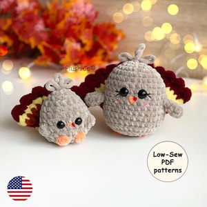 May include: Two handmade crochet turkey figurines. The turkeys are gray with red, yellow, and brown tail feathers. They have black eyes, orange beaks, and orange feet. The image includes the text "Low-Sew PDF patterns".