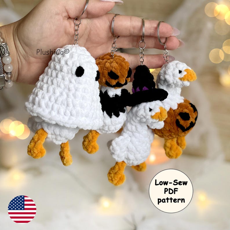 May include: Four handmade Halloween-themed keychains. The keychains are white, orange, and black, with a ghost, pumpkin, witch, and goose design. The keychains are attached to silver keyrings. The text "Low-Sew PDF pattern" is visible.