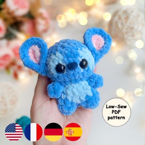 Puede incluir: Un peluche azul tejido a crochet con orejas grandes y ojos negros. El juguete es un personaje de una película de animación popular. Se ve un pequeño círculo blanco con el texto "Low-Sew PDF pattern".