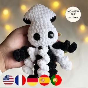 May include: A handmade crochet squid plushie in white and black. The plushie has large black eyes and black accents on the tentacles and head. The image includes a "NO-SEW PDF pattern" graphic.