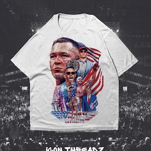 May include: White t-shirt with a graphic print of a mixed martial arts fighter, with the text "Chaos Covington" printed below the image. The graphic features the fighter's face, a championship belt, and an American flag.