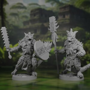 May include: Two grey unpainted miniature lizard-like warrior figures standing on circular bases. The left figure holds a rectangular club and a round shield. The right figure holds a tall staff with a rectangular head. Both wear ornate loincloths.