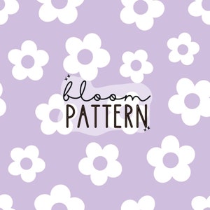 May include: A seamless pattern featuring white stylized flowers on a light purple background. The text "bloom pattern" is centred on the image.