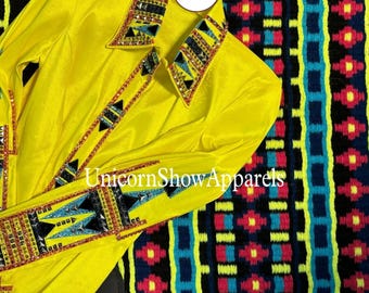 May include: A vibrant yellow show shirt with decorative trim and the text "Unicorn Show Apparels". The shirt is placed next to a patterned saddle pad with a mix of black, blue, red, and yellow.