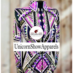 May include: A black, purple, pink, and white show jacket with geometric patterns and rhinestones. The jacket has a zipper closure and a collar. The text "Unicorn Pads & Show Apparels" is on the jacket.