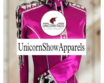 May include: A magenta show shirt with black and white trim and rhinestones. The shirt has a collar and long sleeves. The shirt has the text "Unicorn Pads & Show Apparels" on the front. The text "UnicornShowApparels" is also on the front of the shirt.