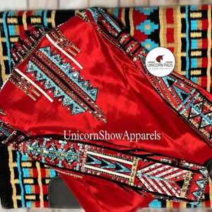 May include: A vibrant red equestrian show jacket with intricate turquoise, white, and silver embellishments. The jacket is displayed over a patterned saddle pad with the text "Unicorn Show Apparels".
