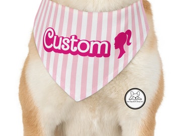 May include: Pink and white striped dog bandana with the word "Custom" in pink letters and a pink silhouette of a woman with a ponytail. The bandana is worn by a light brown dog.