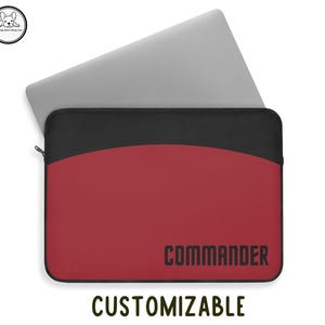 May include: Red laptop sleeve with black trim and the word "COMMANDER" in black lettering. The sleeve is customizable.