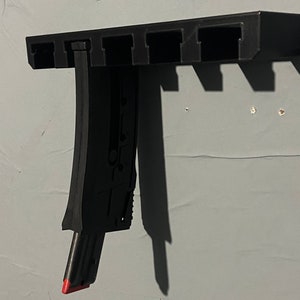 Mossberg 25 round plinkster 702 magazine wall mount .22lr wall mount. Holds 5 magazines www.travmfg.com