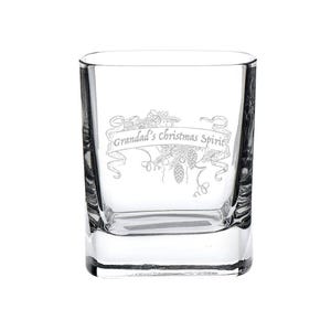 May include: A clear, square-shaped glass with the etched text "Grandad's Christmas Spirit" on a banner with festive botanical illustrations. The glass is designed for spirits and has a thick base.