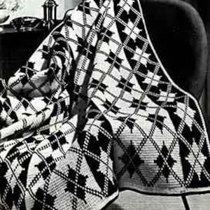 May include: Black and white crochet throw blanket with a geometric diamond pattern. The blanket is draped over a chair.