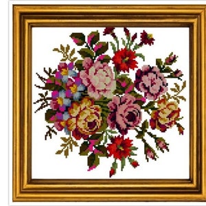 May include: A framed cross-stitch floral arrangement featuring a bouquet of colorful flowers. The flowers include pink, red, yellow, and purple blooms with green leaves. The artwork is set in a gold-colored frame.