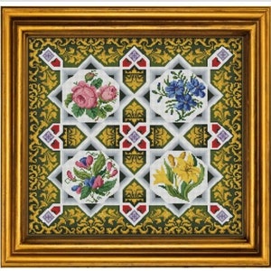 May include: Framed floral cross-stitch artwork. The piece features four square floral designs, including roses, irises, and other flowers, set against a patterned background. The frame is gold-colored.